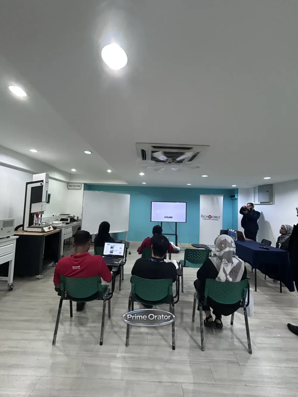 Participants seated and following along on laptops during a Coaching Mindset for Leaders training session